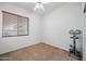 Bright bedroom with ceiling fan and window blinds at 1082 W Aspen Ave, Gilbert, AZ 85233