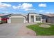 Front view of a house with a garage and attractive landscaping at 1082 W Aspen Ave, Gilbert, AZ 85233