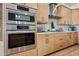 Stainless steel appliances in a modern kitchen with light wood cabinets at 1082 W Aspen Ave, Gilbert, AZ 85233