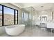 Luxurious bathroom with soaking tub, glass shower, and mountain views at 10944 E Whistling Wind Way, Scottsdale, AZ 85255