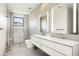 Modern bathroom with double vanity, glass shower, and marble tile at 10944 E Whistling Wind Way, Scottsdale, AZ 85255