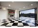 Modern garage with checkered floor, fireplace, and mountain views at 10944 E Whistling Wind Way, Scottsdale, AZ 85255