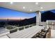 Outdoor dining area with a long table and chairs, overlooking scenic mountains at 10944 E Whistling Wind Way, Scottsdale, AZ 85255