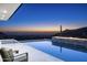 Luxury pool and spa at dusk with mountain views at 10944 E Whistling Wind Way, Scottsdale, AZ 85255