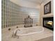 Relaxing bathroom with a large bathtub and fireplace at 12308 N 119Th St, Scottsdale, AZ 85259