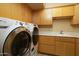 Bright laundry room with a front-load washer and dryer at 12308 N 119Th St, Scottsdale, AZ 85259