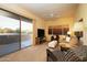 Comfortable living room with a cozy seating area and sliding door access to patio at 12308 N 119Th St, Scottsdale, AZ 85259