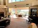 Bright living room with sliding glass doors opening to a patio overlooking a pool and golf course at 12308 N 119Th St, Scottsdale, AZ 85259