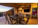 Covered patio features an outdoor kitchen, dining area, and stunning sunset views at 12308 N 119Th St, Scottsdale, AZ 85259