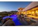 Inviting pool and spa area with stunning desert landscape views at night at 12308 N 119Th St, Scottsdale, AZ 85259