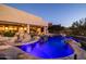 Dramatic nighttime view of the pool with blue lighting and stone accents at 12308 N 119Th St, Scottsdale, AZ 85259