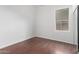 Simple bedroom with wood flooring and window at 12418 W Pima St, Avondale, AZ 85323