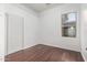 Well-lit bedroom featuring wood floors and a closet at 12418 W Pima St, Avondale, AZ 85323