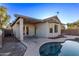 Home's back exterior boasts a covered patio and pool at 12418 W Pima St, Avondale, AZ 85323