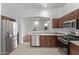 Stainless steel appliances and wood cabinets in this updated kitchen at 12418 W Pima St, Avondale, AZ 85323