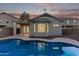 Inviting backyard pool with exterior lighting at 12418 W Pima St, Avondale, AZ 85323