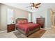 Main bedroom with a king-size bed, dresser, and ceiling fan at 12736 W Auburn Dr, Peoria, AZ 85383