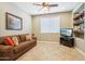 Cozy den with a brown couch, built-in shelving, and a flat-screen TV at 12736 W Auburn Dr, Peoria, AZ 85383