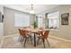 Bright dining room features a wood table with leather chairs, and views into the living room at 12736 W Auburn Dr, Peoria, AZ 85383