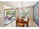 Bright dining area with wood table and chairs, and sliding glass doors to patio at 12736 W Auburn Dr, Peoria, AZ 85383