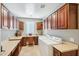 Well-equipped laundry room with ample cabinetry and workspace at 12736 W Auburn Dr, Peoria, AZ 85383