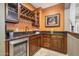 Convenient wet bar with wine rack, beverage fridge, and dark wood cabinetry at 12736 W Auburn Dr, Peoria, AZ 85383