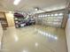 Large garage with ample storage shelving and epoxy flooring at 12762 W Vista Paseo Dr, Litchfield Park, AZ 85340