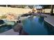 Relaxing pool and spa area with rock waterfall feature at 12762 W Vista Paseo Dr, Litchfield Park, AZ 85340