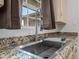 Modern kitchen sink with a pull-down faucet and granite countertops at 1312 E Colter St, Phoenix, AZ 85014