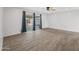 Bright living room with sliding glass doors and wood-look tile at 1312 E Colter St, Phoenix, AZ 85014