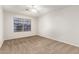 Well-lit bedroom with ceiling fan and window at 13292 W Statler St, Surprise, AZ 85374