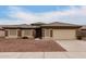 Tan house with tile roof, attached garage, and small front yard at 13292 W Statler St, Surprise, AZ 85374