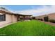 Back exterior view of house with grassy yard and patio at 13292 W Statler St, Surprise, AZ 85374