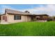 Back exterior view showing house, patio and yard at 13292 W Statler St, Surprise, AZ 85374