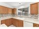 Corner kitchen sink with white cabinets and tile at 13292 W Statler St, Surprise, AZ 85374