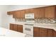 White appliances and wood cabinets in this kitchen at 13292 W Statler St, Surprise, AZ 85374