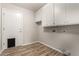 Laundry room with white cabinets and wood-look flooring at 13292 W Statler St, Surprise, AZ 85374