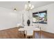 Bright dining room with glass table and four white chairs at 14402 N 45Th St, Phoenix, AZ 85032