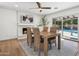 Dining room with fireplace, wooden table and pool view at 14402 N 45Th St, Phoenix, AZ 85032