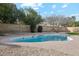 Kidney-shaped swimming pool surrounded by gravel at 14402 N 45Th St, Phoenix, AZ 85032