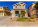 Two-story house with a landscaped front yard, and a walkway leading to the entrance at 14518 W Port Royale Ln, Surprise, AZ 85379