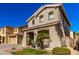 Two-story house with a landscaped front yard, and a walkway leading to the entrance at 14518 W Port Royale Ln, Surprise, AZ 85379