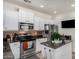 Modern kitchen with white cabinets, granite countertops, and stainless steel appliances at 14518 W Port Royale Ln, Surprise, AZ 85379