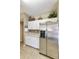 Kitchen features stainless steel refrigerator and white cabinets at 1621 E Firestone Dr, Chandler, AZ 85249