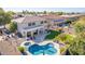 Aerial view showing home's backyard oasis with pool, spa, and expansive lawn at 1684 E Coconino Dr, Chandler, AZ 85249