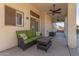 Relaxing back patio with wicker furniture and ceiling fans at 1684 E Coconino Dr, Chandler, AZ 85249