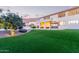 Expansive backyard with artificial turf, landscaped areas, and an outdoor seating area at 1684 E Coconino Dr, Chandler, AZ 85249