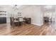 Open concept dining room with table and chairs, hardwood floors and built-in shelving at 1684 E Coconino Dr, Chandler, AZ 85249