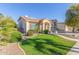 Two story house with solar panels and nicely landscaped lawn at 1684 E Coconino Dr, Chandler, AZ 85249