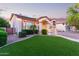 Beautiful home with lush green lawn, manicured landscaping, and a welcoming entrance at 1684 E Coconino Dr, Chandler, AZ 85249
